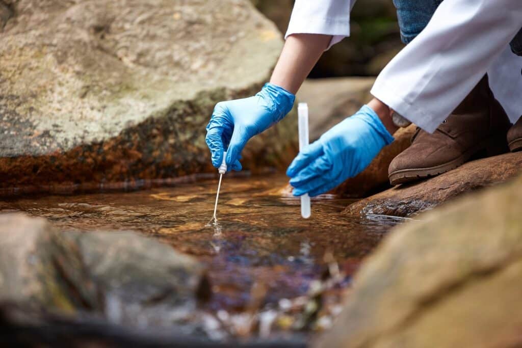 Prélèvement d'un échantillon d'eau dans un cours d'eau pour analyse