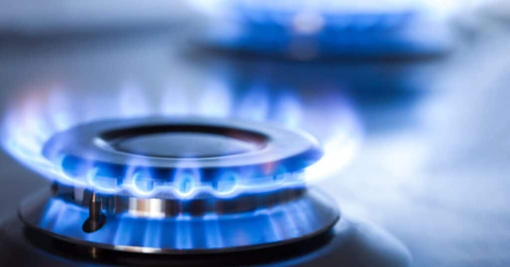 Gros plan sur une flamme de gaz bleue sur une cuisinière